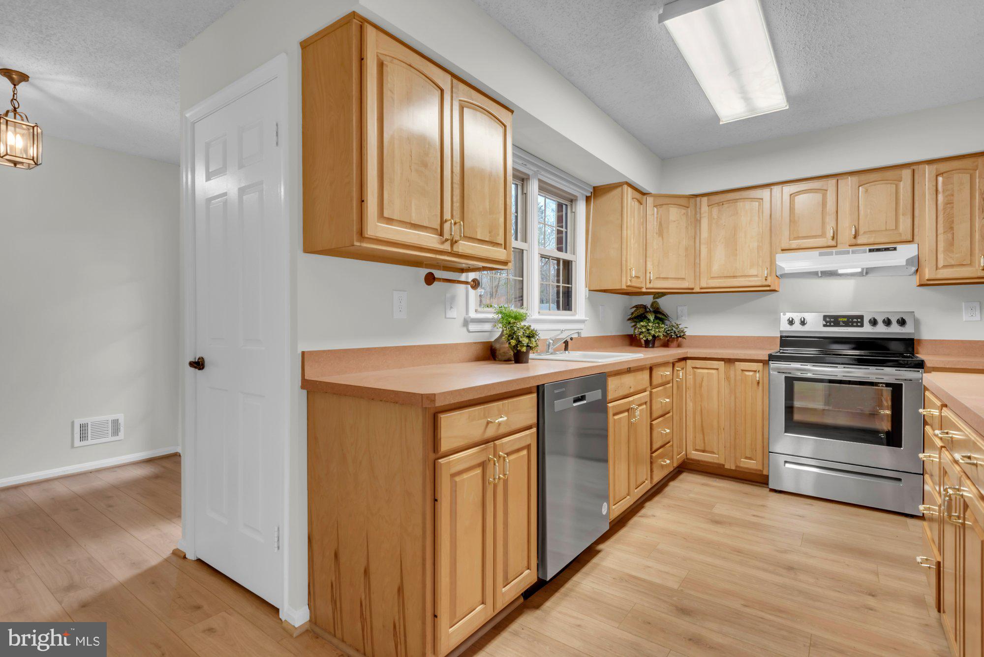 2572 Golfers Ridge Road Annapolis, MD 21401 - Photo 22 of 69 a kitchen with granite countertop a sink cabinets stainless steel appliances and a window