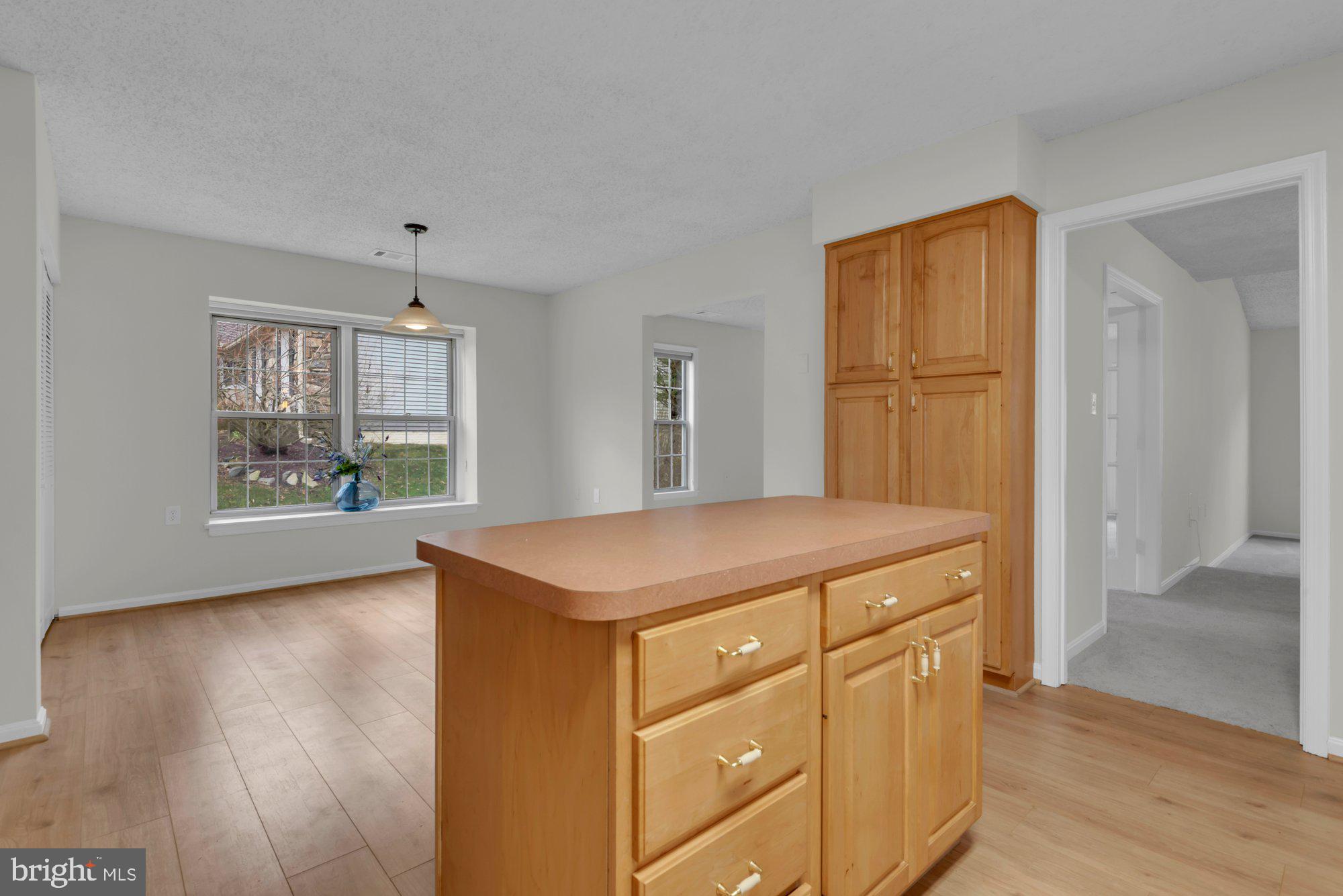 2572 Golfers Ridge Road Annapolis, MD 21401 - Photo 25 of 69 a hall with kitchen island a sink wooden floor and a refrigerator