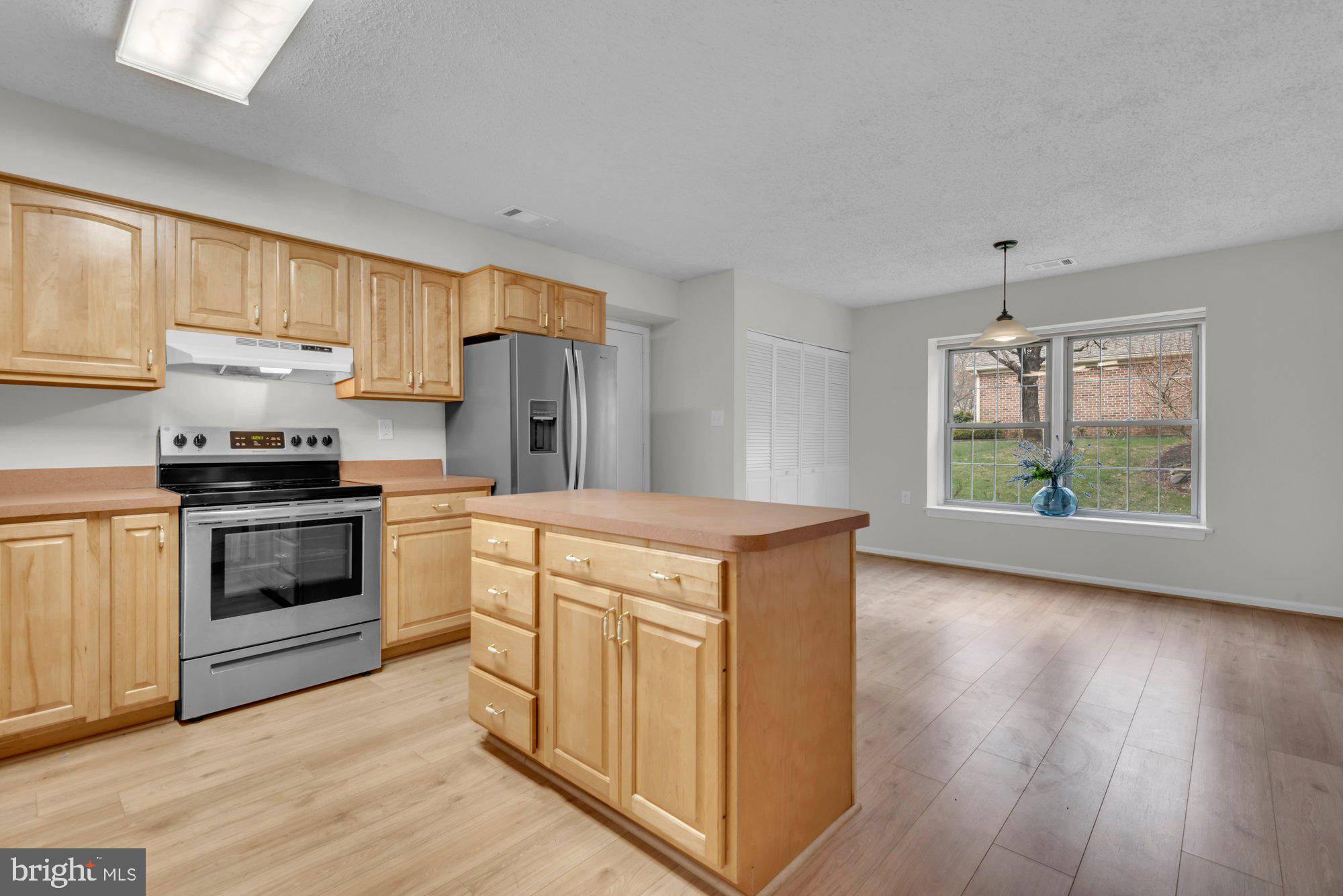 2572 Golfers Ridge Road Annapolis, MD 21401 - Photo 27 of 69 a kitchen with stainless steel appliances white cabinets and wooden floors