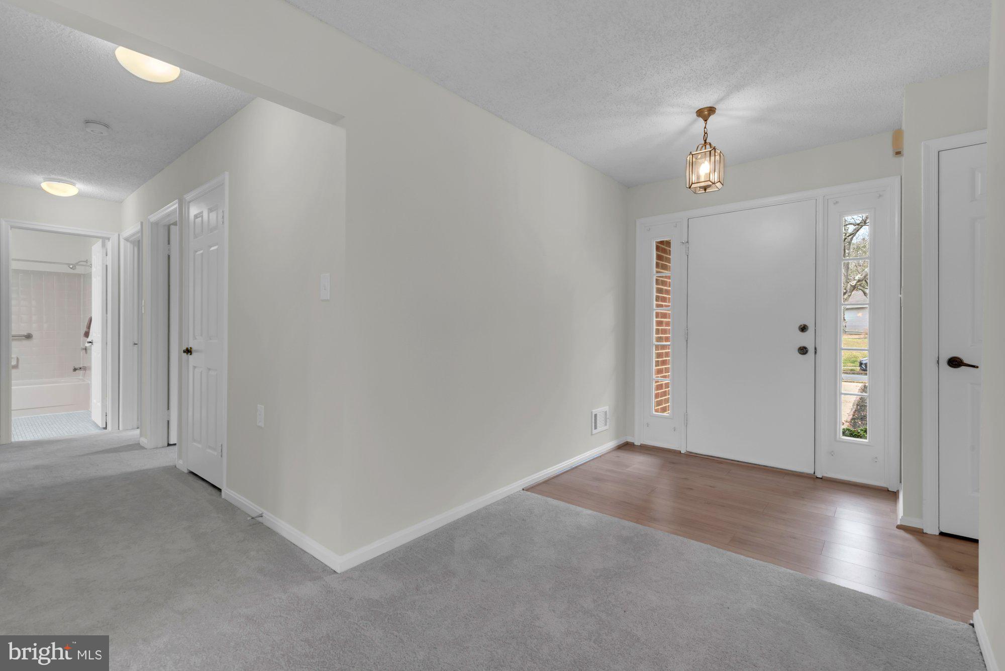2572 Golfers Ridge Road Annapolis, MD 21401 - Photo 4 of 69 an empty room with wooden floor and windows