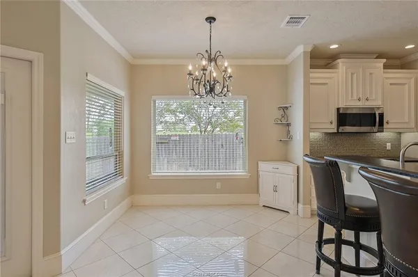 a spacious bathroom with a granite countertop sink a large mirror and a bathtub