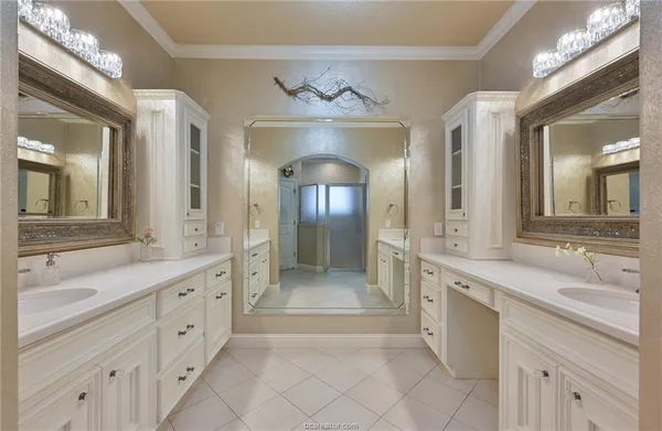 a large bathroom with a double vanity sink and a mirror