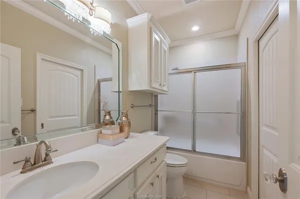 a bathroom with a sink toilet a mirror and shower