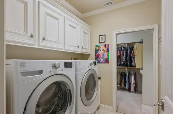 a view of storage and utility room with washer and dryer