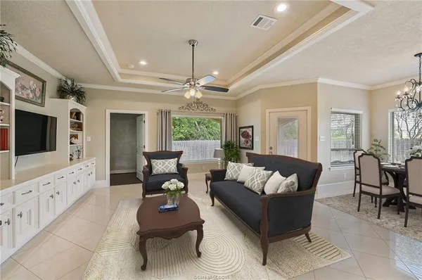 a living room with furniture or chandelier and a flat screen tv