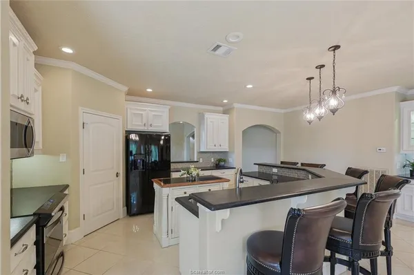 a kitchen with a sink cabinets and refrigerator