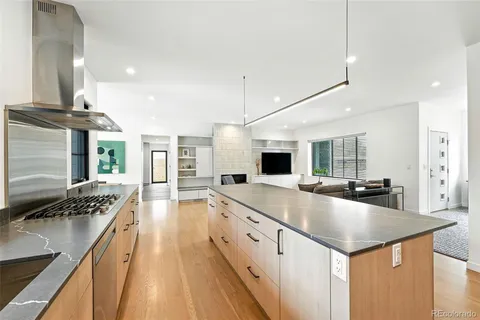 a kitchen with stainless steel appliances granite countertop a sink stove and refrigerator