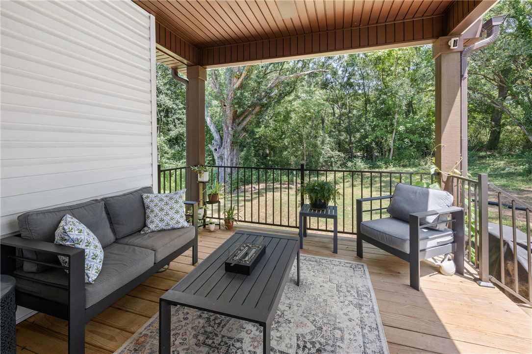 322 Thompson Street Pendleton, SC 29670 - Photo 30 of 38 An inviting covered back porch features wood flooring and overlooks a lush, wooded yard.