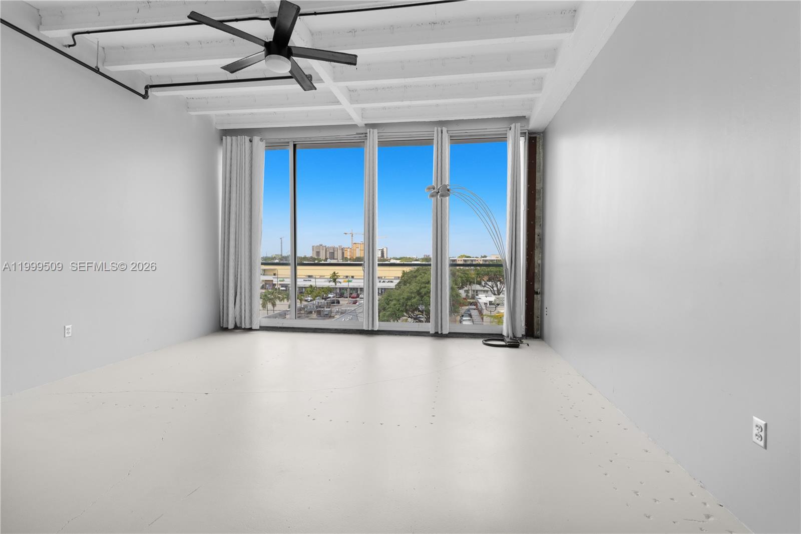 8101 Biscayne Boulevard, Unit R414 Miami, FL 33138 - Photo 6 of 27 a view of an empty room with a window