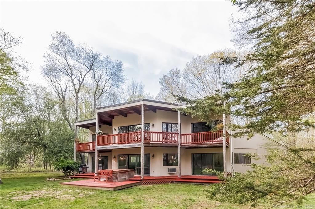 587 Long Hill Road Guilford, CT 06437 - Photo 1 of 1 a view of a big building with plants and large trees