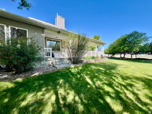 812 East Bates Cyn Road Tooele, UT 84074 - Photo 103 of 144 Spacious lawn bordered by mature trees and a fenced perimeter