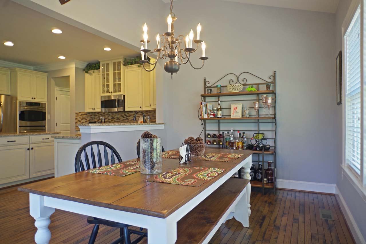 184 Ridgemont Road Ruckersville, VA 22968 - Photo 15 of 50 a view of a dining room with furniture a chandelier and wooden floor