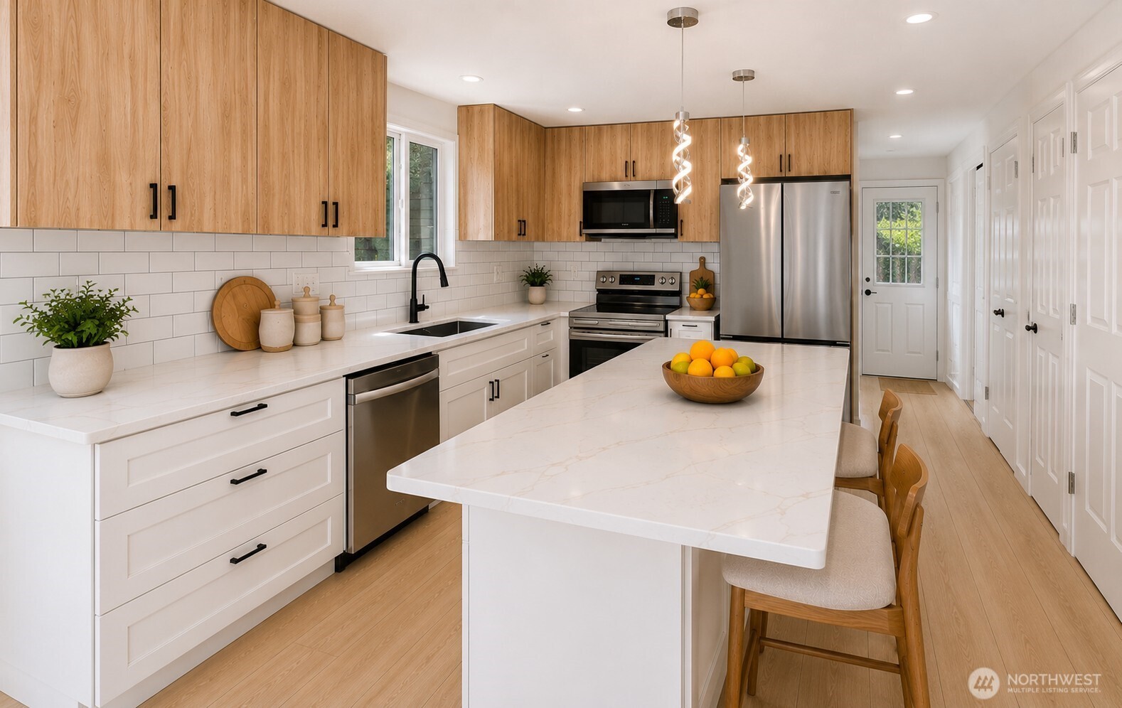 7605 Northeast Hidden Cove Road Bainbridge Island, WA 98110 - Photo 5 of 36 a kitchen with white cabinets and appliances