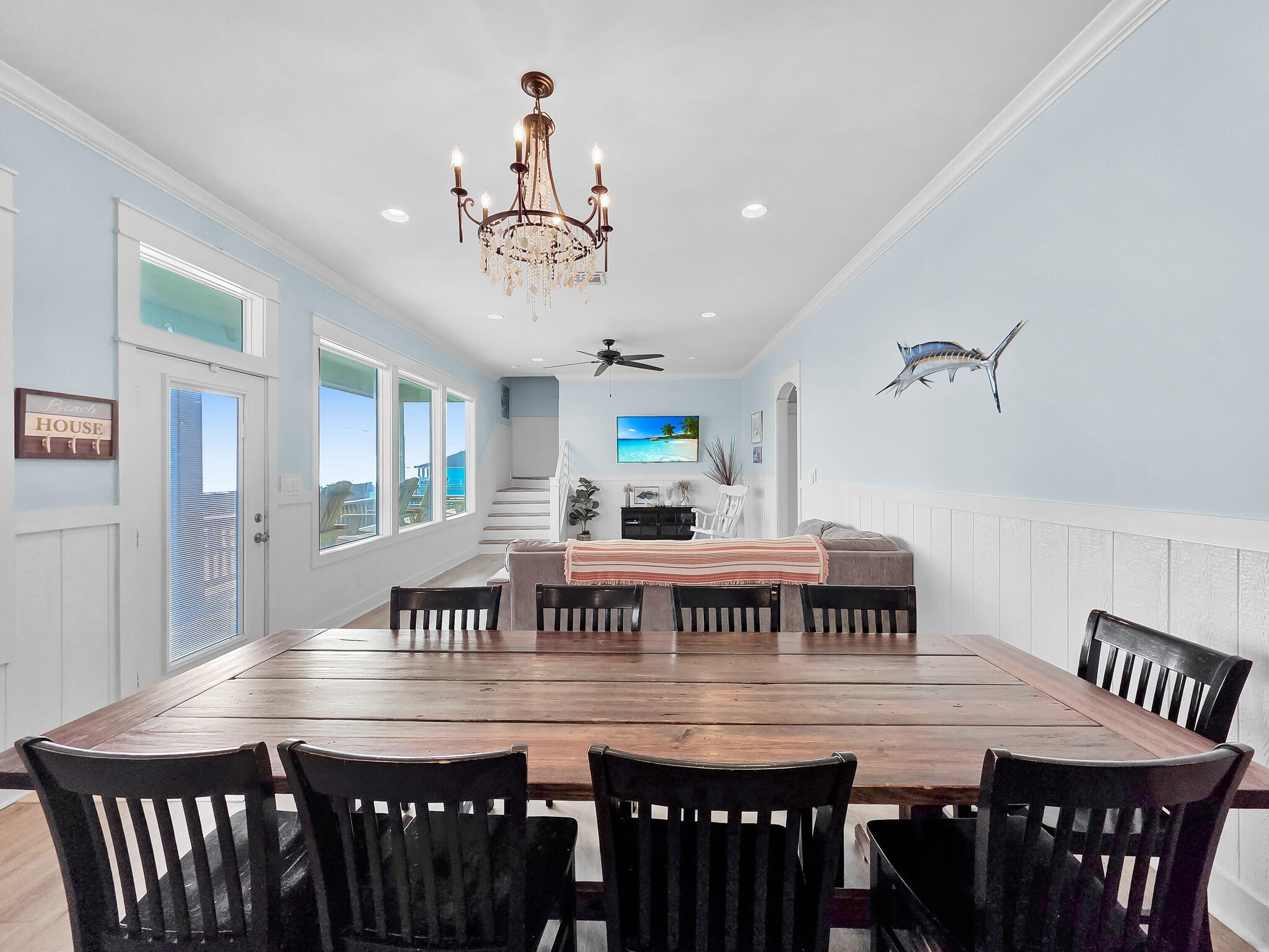 816 South Crystal Beach Road Crystal Beach, TX 77650 - Photo 17 of 48 a view of a dining room with furniture wooden floor and chandelier