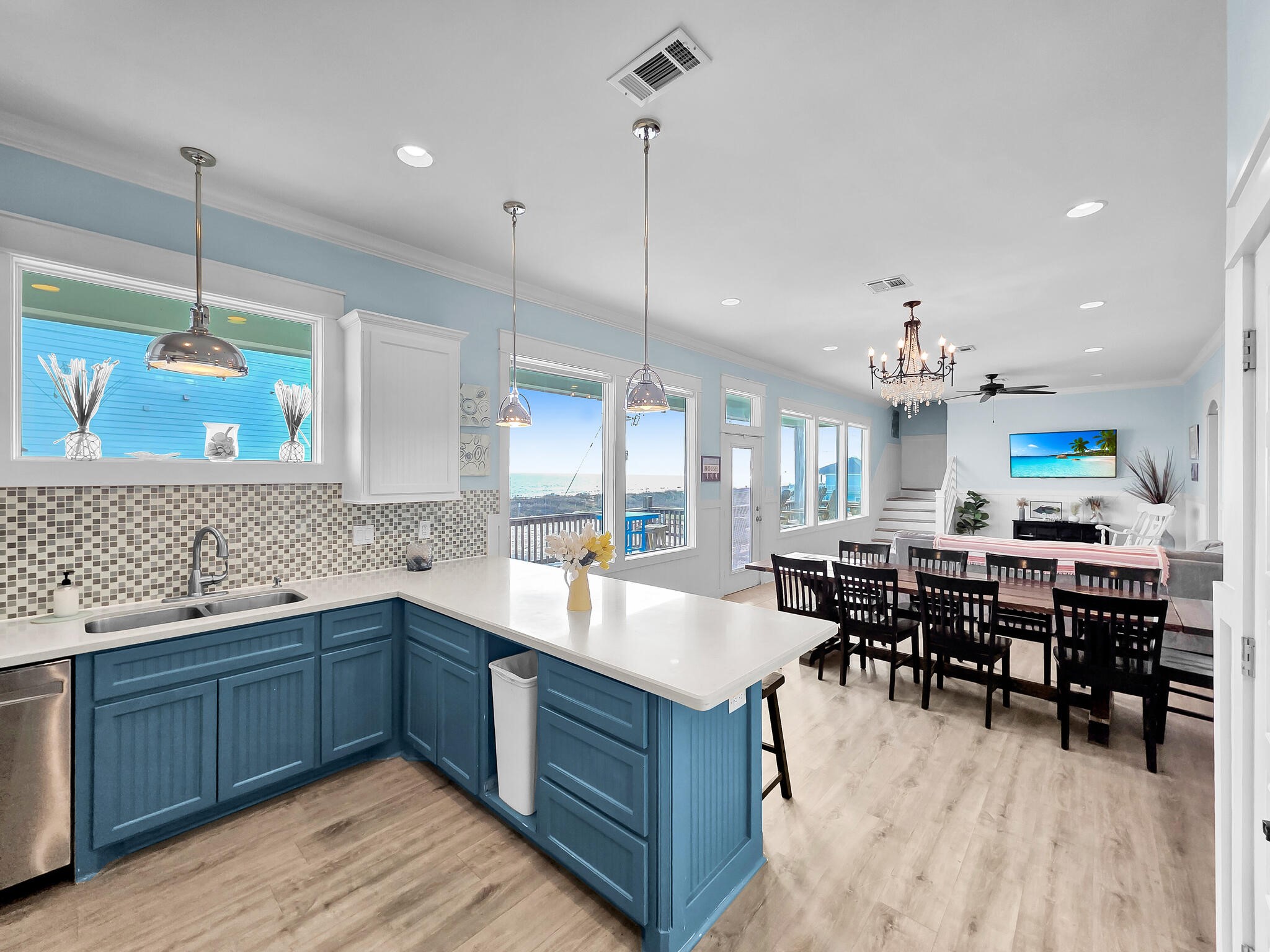 816 South Crystal Beach Road Crystal Beach, TX 77650 - Photo 23 of 48 a large kitchen with lots of counter space a sink dining table and chairs