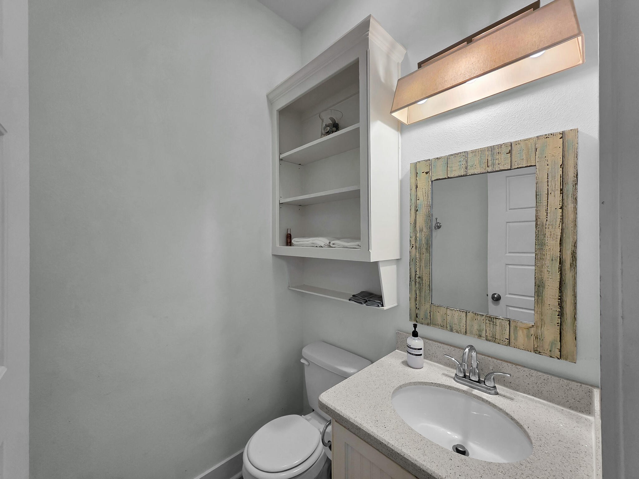 816 South Crystal Beach Road Crystal Beach, TX 77650 - Photo 32 of 48 a bathroom with a sink and a mirror