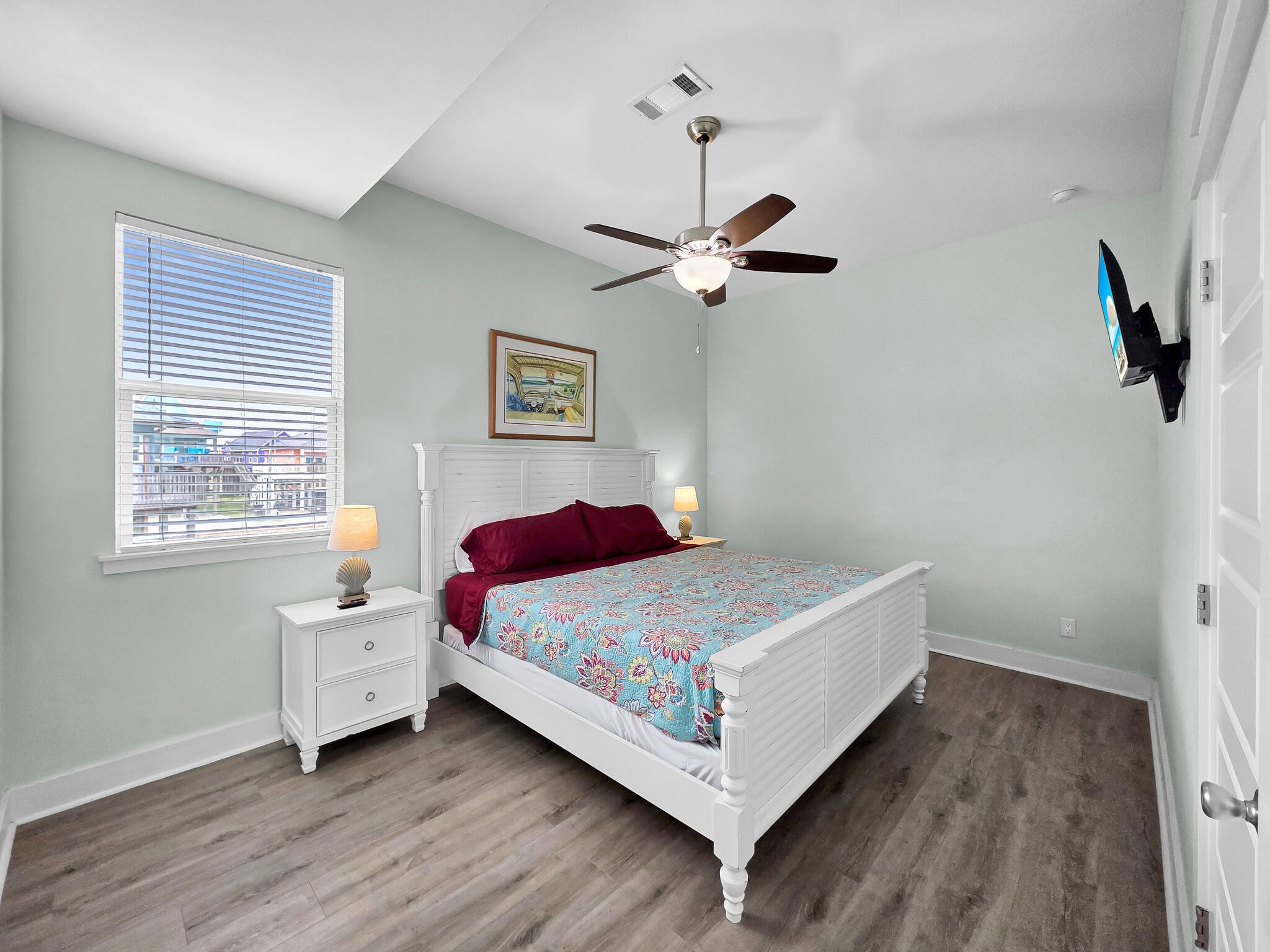 816 South Crystal Beach Road Crystal Beach, TX 77650 - Photo 33 of 48 a bedroom with a bed chandelier and a window