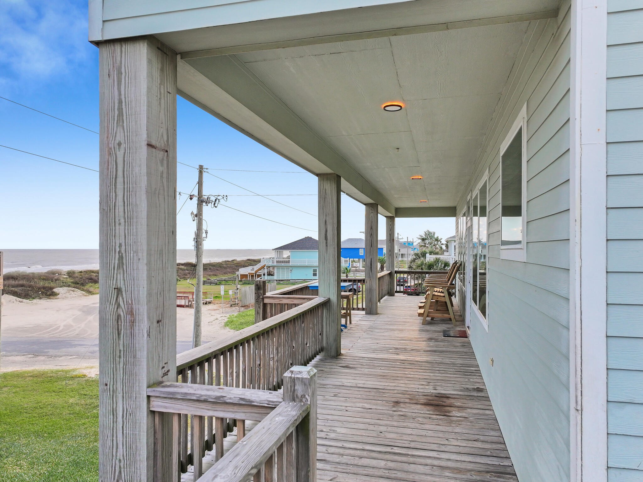 816 South Crystal Beach Road Crystal Beach, TX 77650 - Photo 7 of 48 a view of a balcony with chairs and wooden floor
