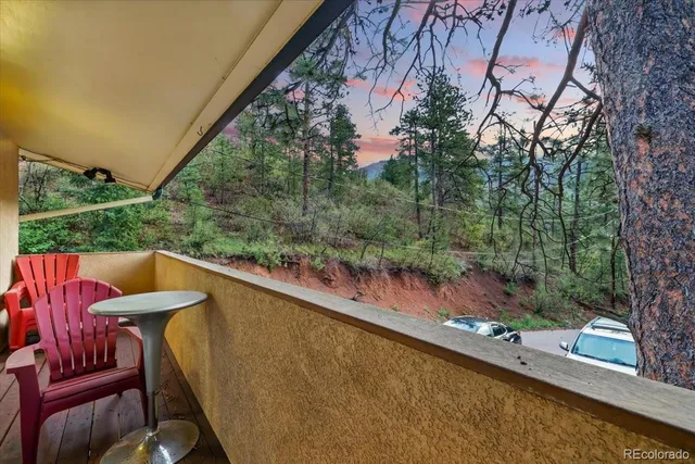 a view of balcony with furniture and wooden fence