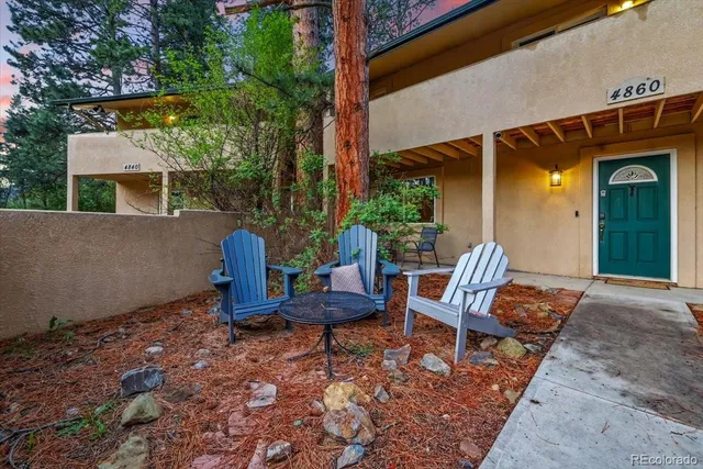 a view of two chairs in the patio