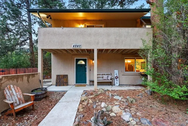 a view of a chairs and table in the backyard