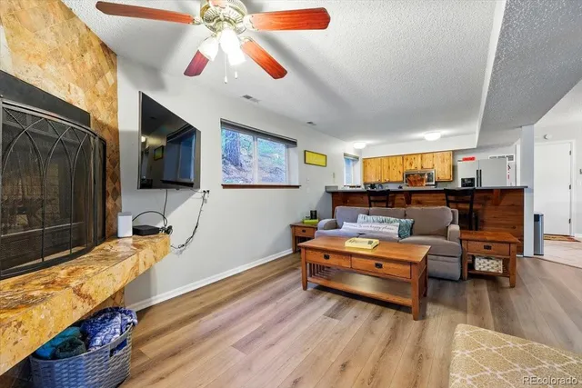 a view of a dining room with furniture a chandelier and wooden floor