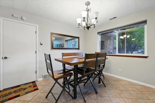 a dining table with chairs and window