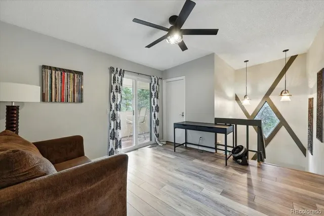 a living room with furniture and a wooden floor