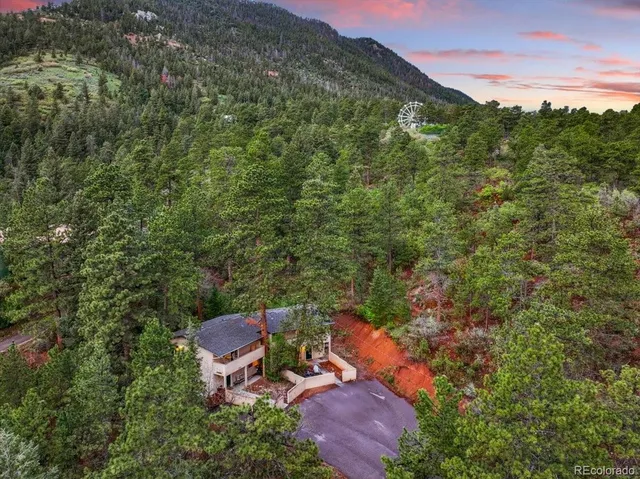an aerial view of a house with mountain view