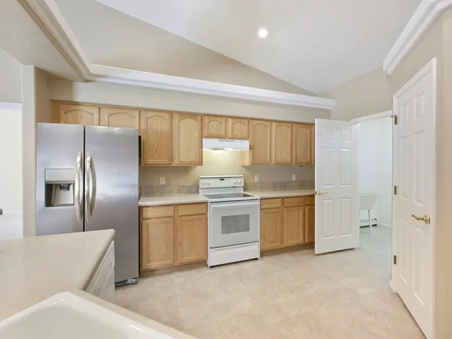a kitchen with a refrigerator stove and sink