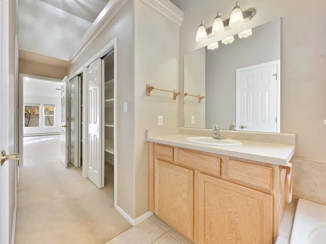 a bathroom with a double vanity sink and mirror