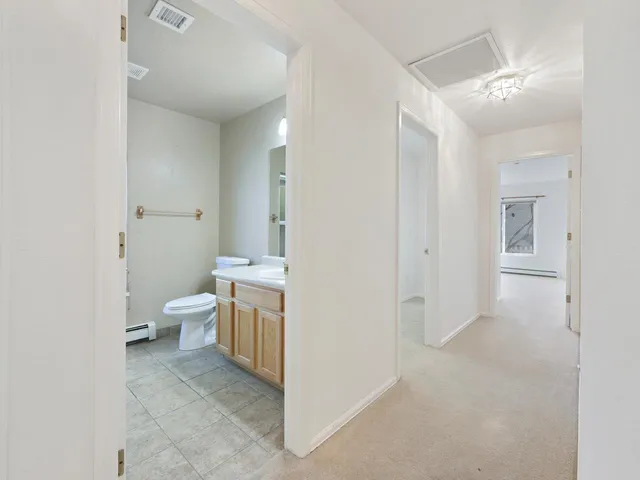 a bathroom with a toilet sink and a mirror