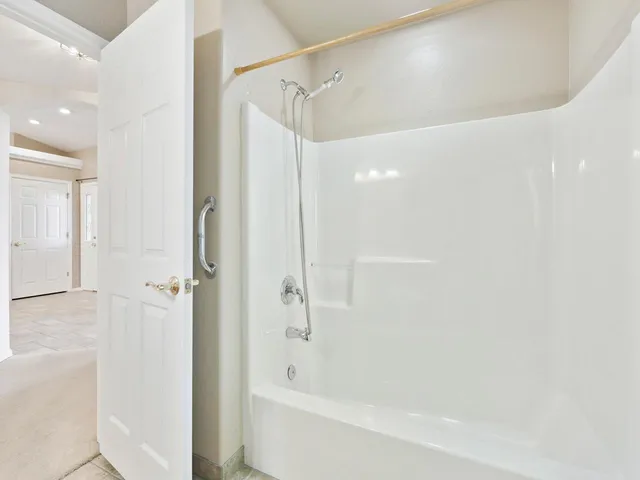 a bathroom with a bathtub and a shower