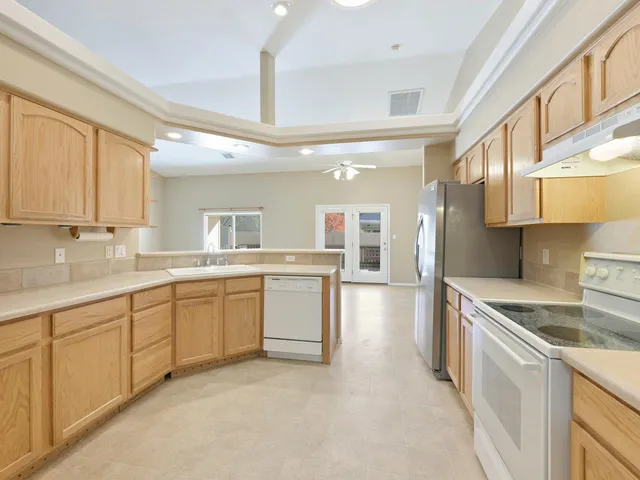 a large kitchen with cabinets and stainless steel appliances