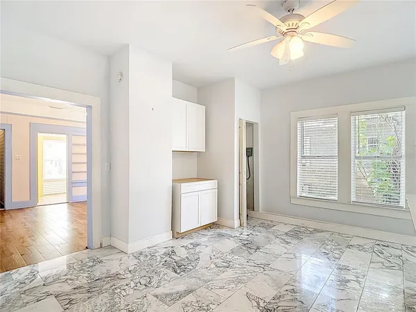 a kitchen with white cabinets appliances and a sink