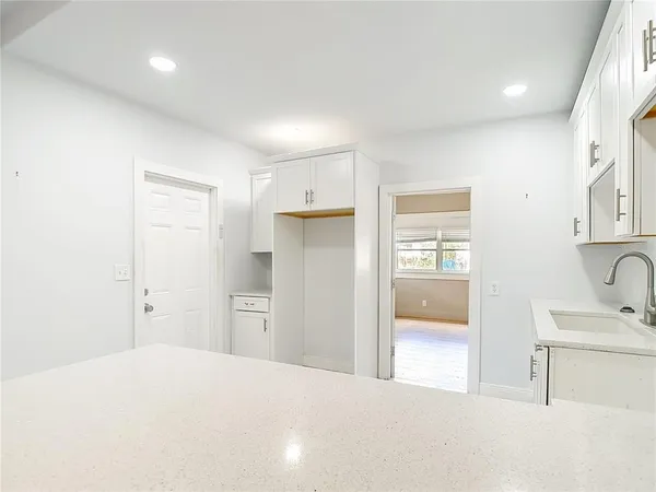 a view of a kitchen with wooden floor and windows