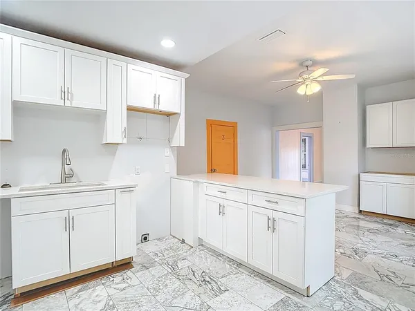 a kitchen with granite countertop a sink and a stove top oven