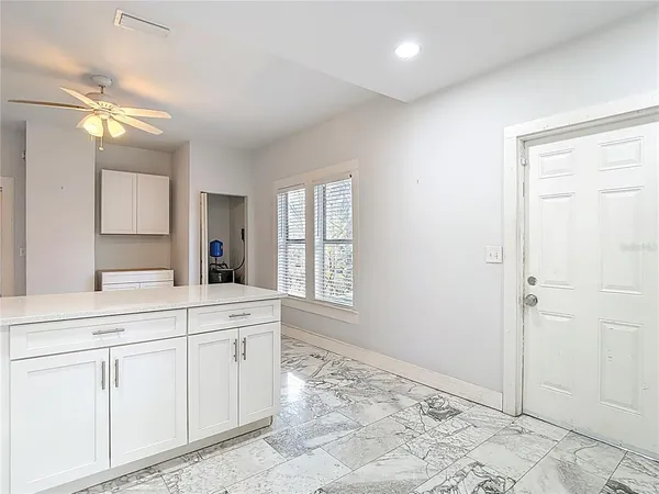 a view of kitchen with wooden floor and electronic appliances