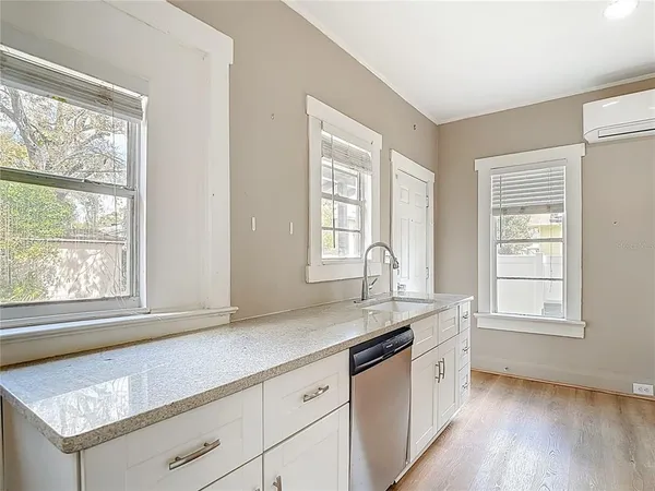 a view of an empty room with wooden floor