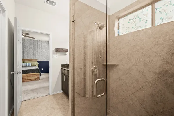 a bathroom with a shower and a sink