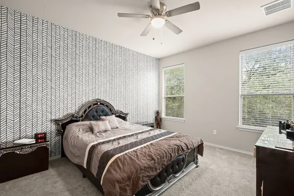 a bedroom with a bed and a window