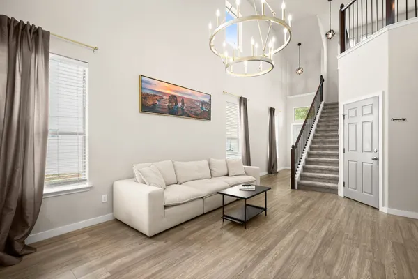 a living room with furniture and wooden floor