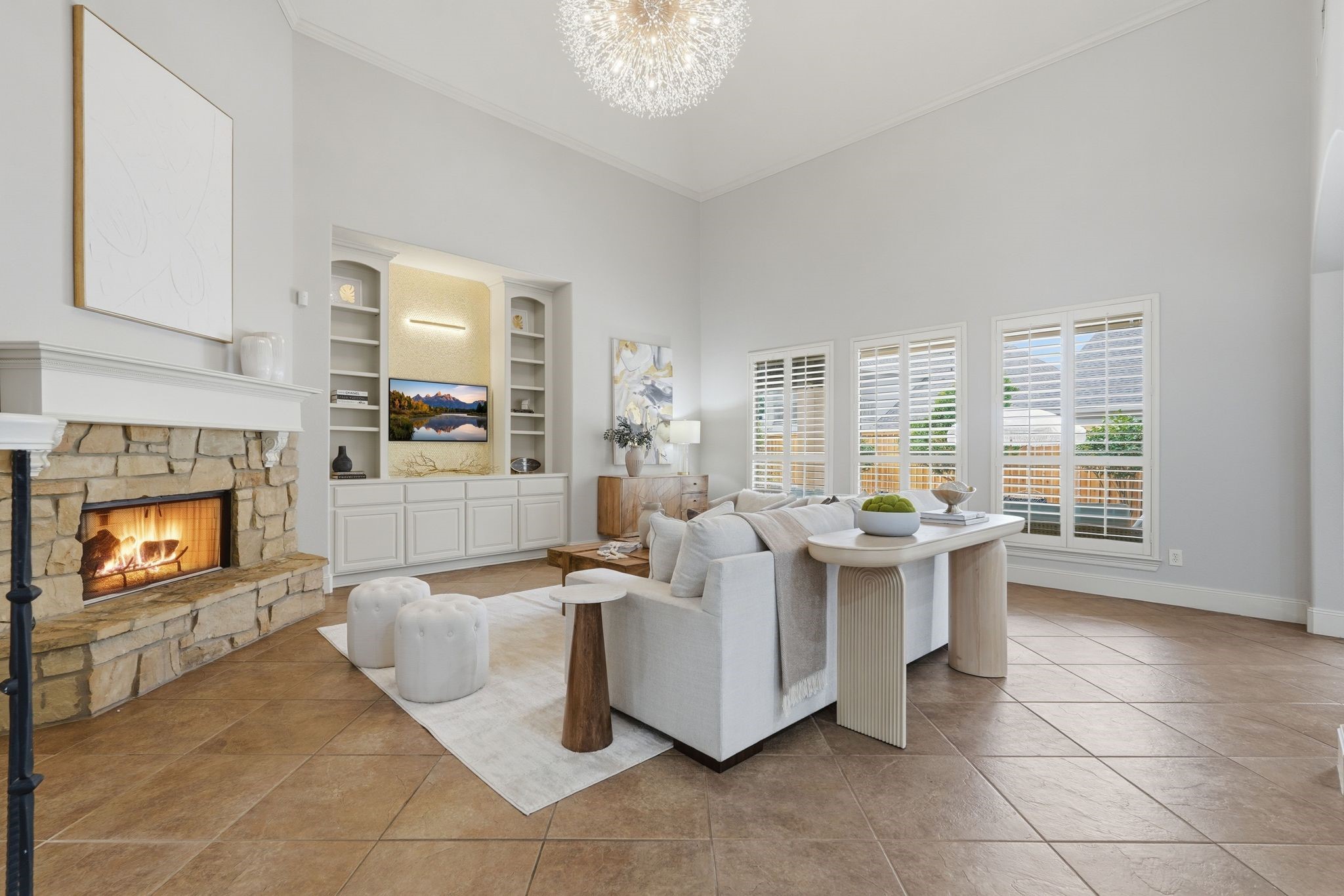 7603 Hogan Bridge Court Spring, TX 77389 - Photo 11 of 50 Custom lighting and a statement accent wall create a sophisticated focal point in this inviting living room.