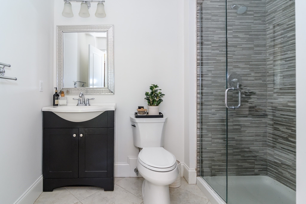 2 Hunters Lane Natick, MA 01760 - Photo 23 of 40 a bathroom with a sink a toilet and mirror