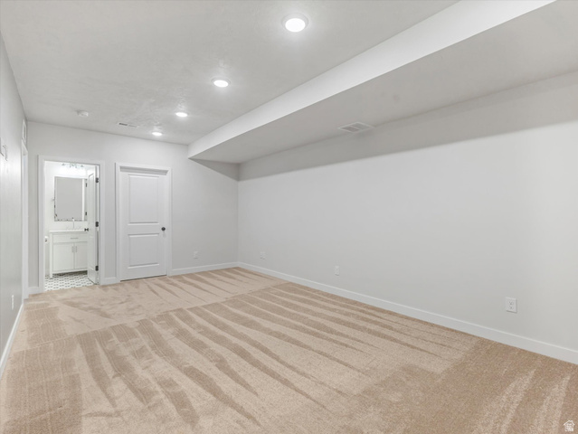 11759 South Watercourse Road South Jordan, UT 84009 - Photo 18 of 33 Neutral tone carpeted room with recessed lighting and white baseboards
