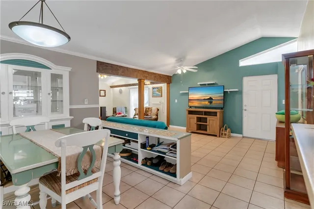 a kitchen with stainless steel appliances kitchen island granite countertop a table and chairs in it