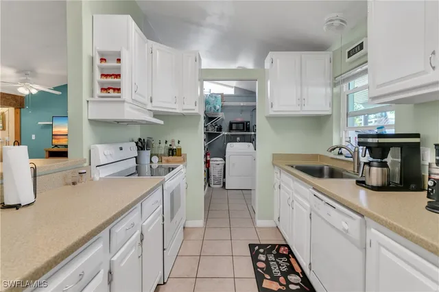 a kitchen with cabinets and window