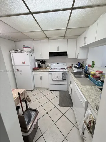 a kitchen with a sink a stove and cabinets