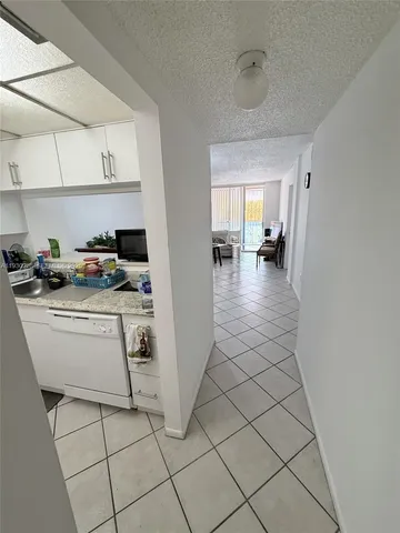 a kitchen with sink cabinets and stove top oven