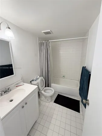 a bathroom with a toilet a sink a mirror and a bathtub